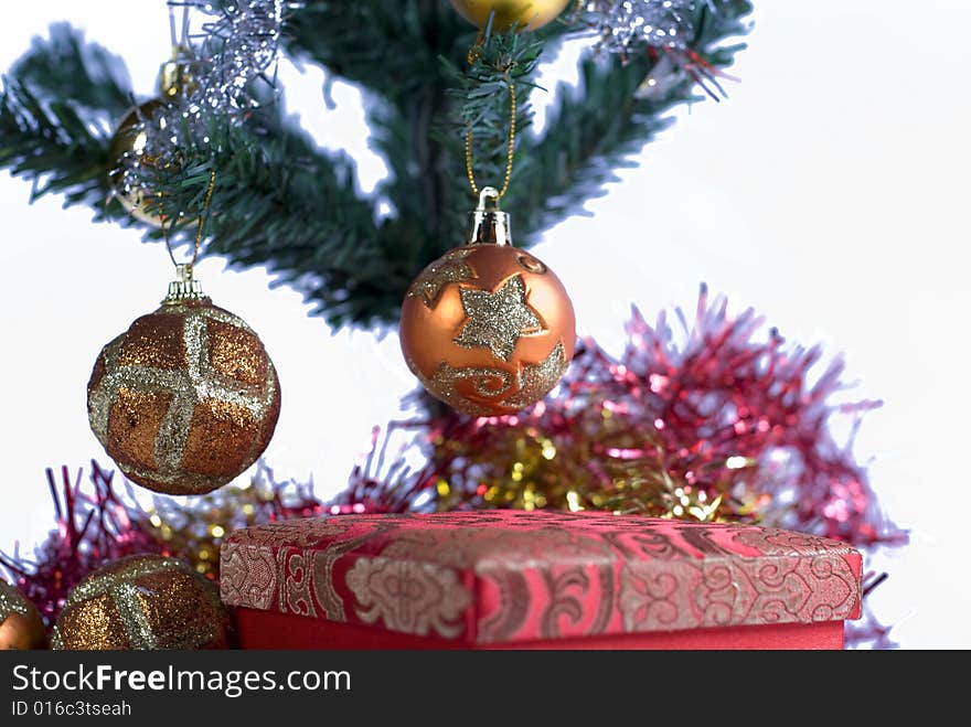 Present box under the Christmas tree isolated on a white background. Present box under the Christmas tree isolated on a white background.