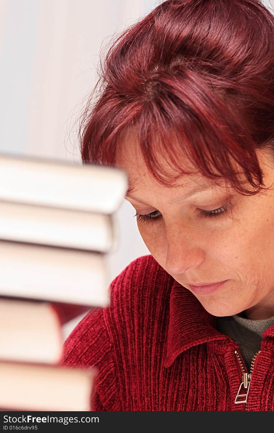 The woman closely studying the literature. The woman closely studying the literature