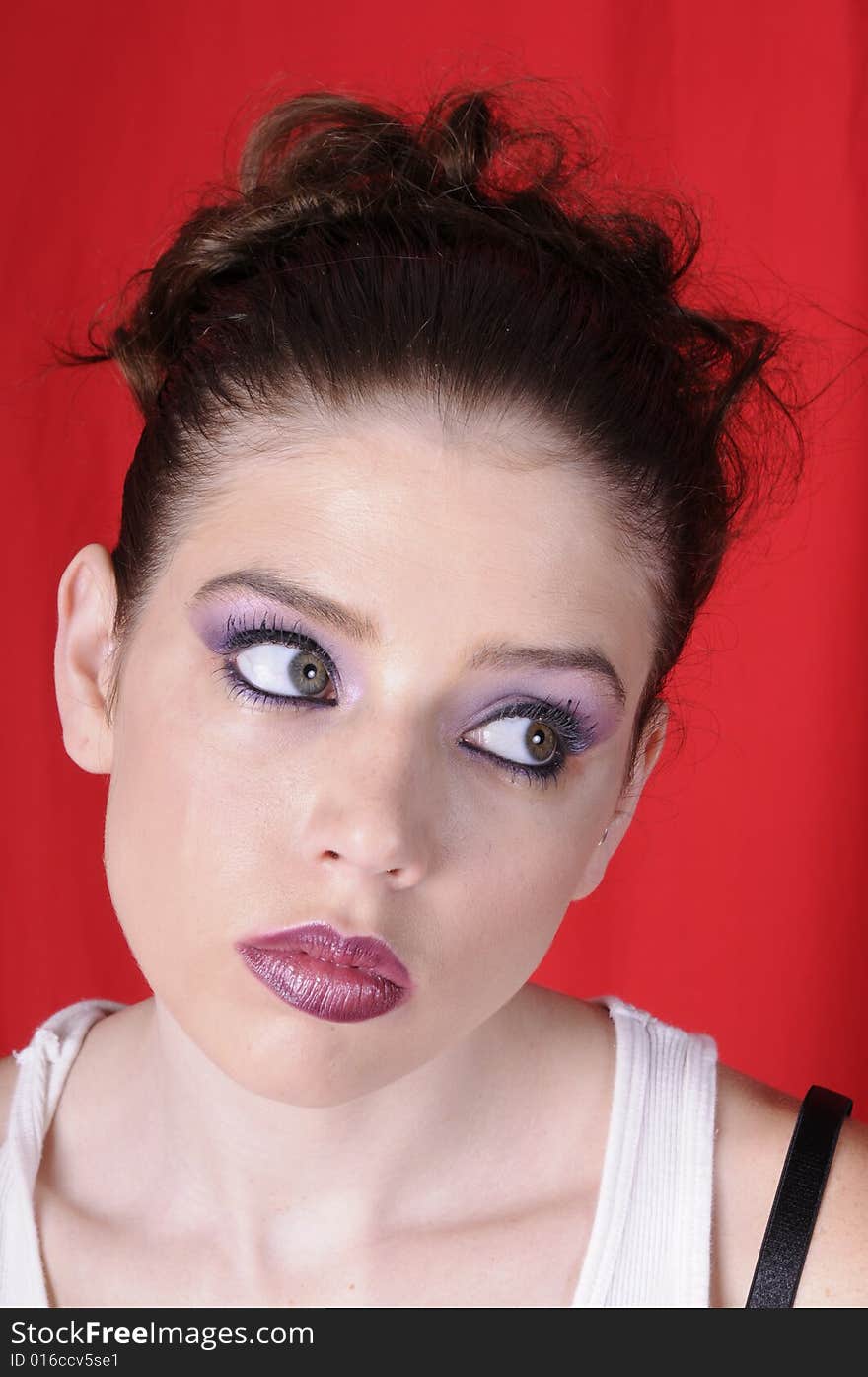 Beautiful young brunette woman in closeup over a red background. Beautiful young brunette woman in closeup over a red background