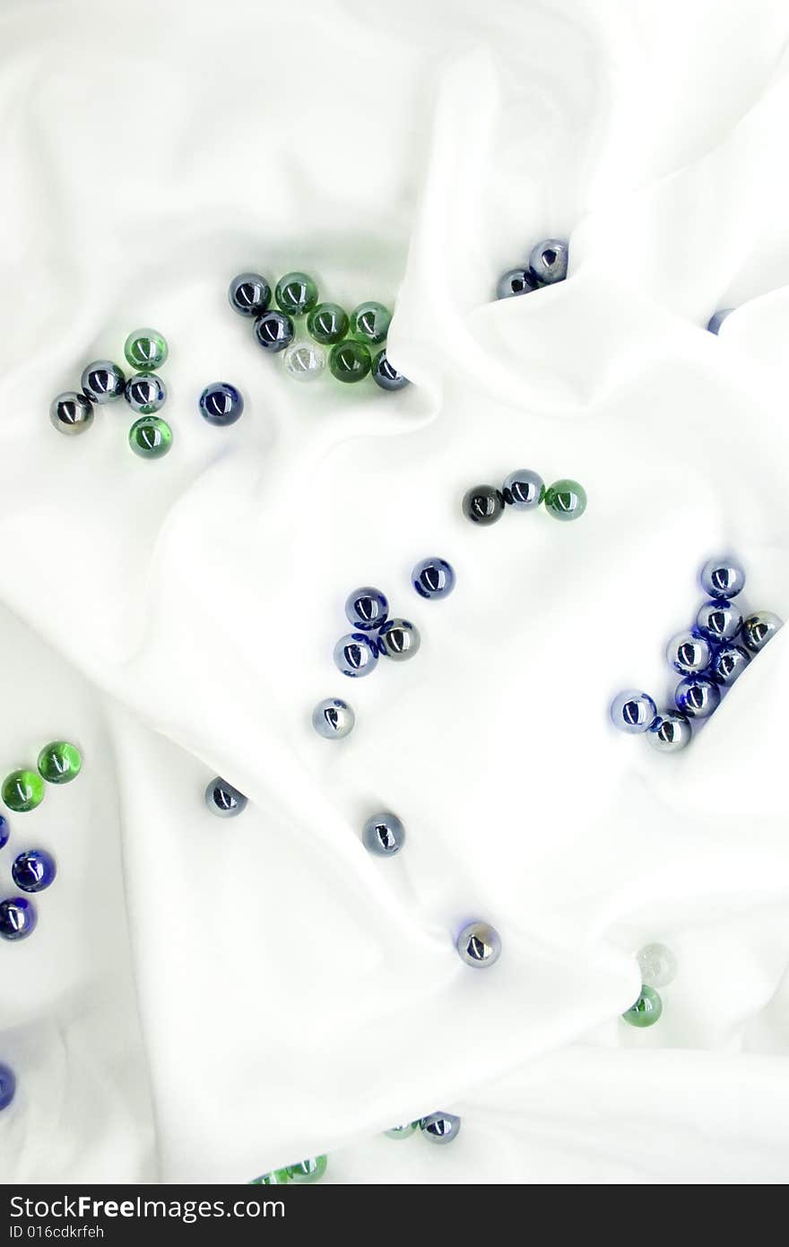 Glass balls on white silk