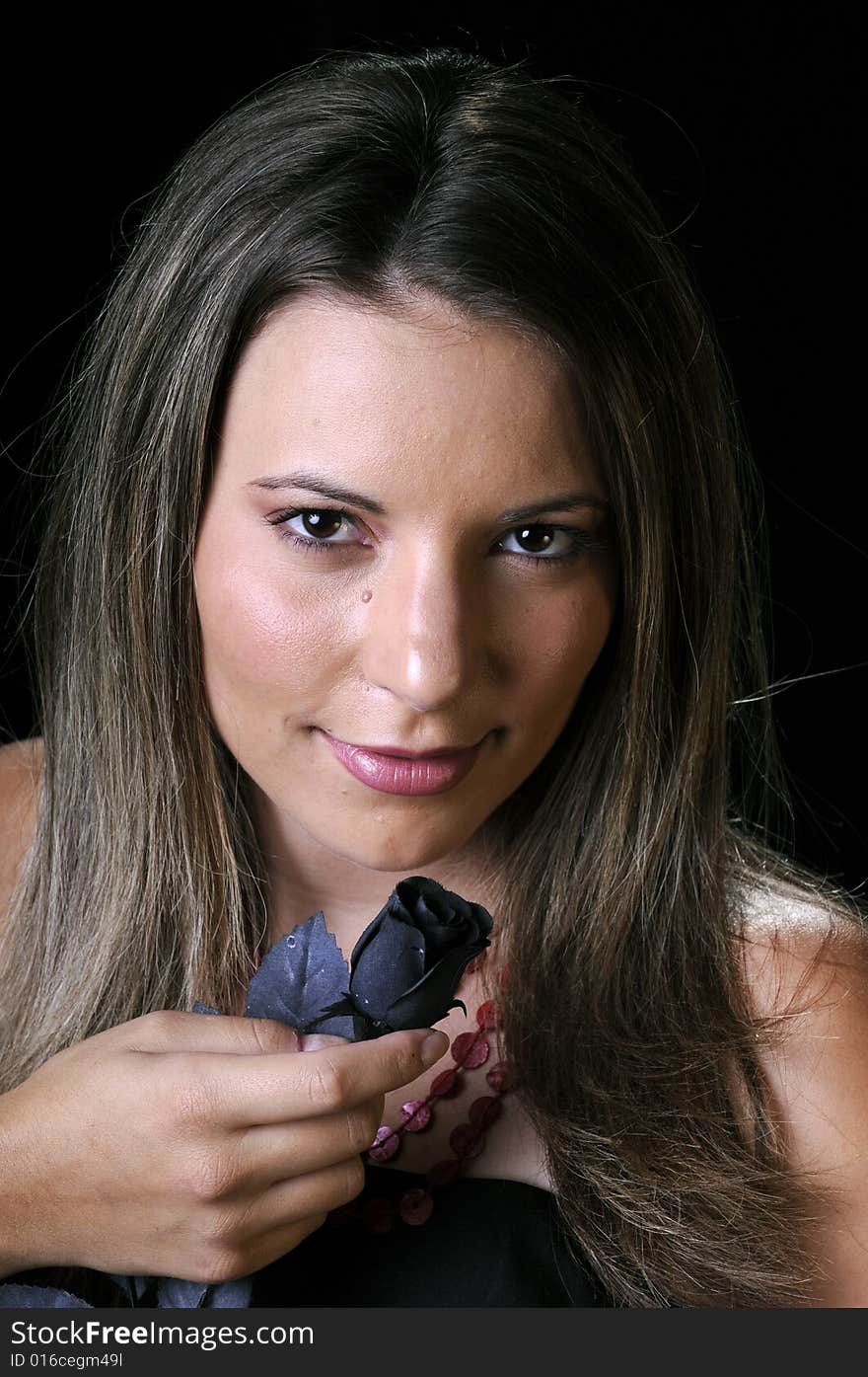 Beautiful young brunette woman with black rose for Halloween. Beautiful young brunette woman with black rose for Halloween