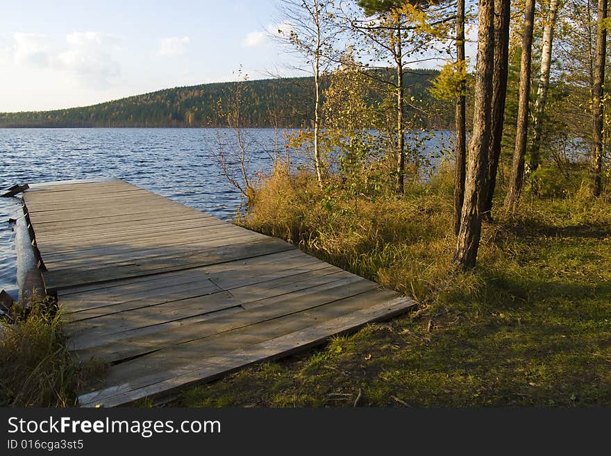 Old wooden moorage on a lake shot at sunset light