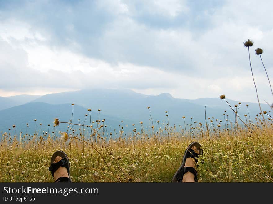 Summer mountain landscape in Crimea, Ukraine. Feet on foreground. Summer mountain landscape in Crimea, Ukraine. Feet on foreground.