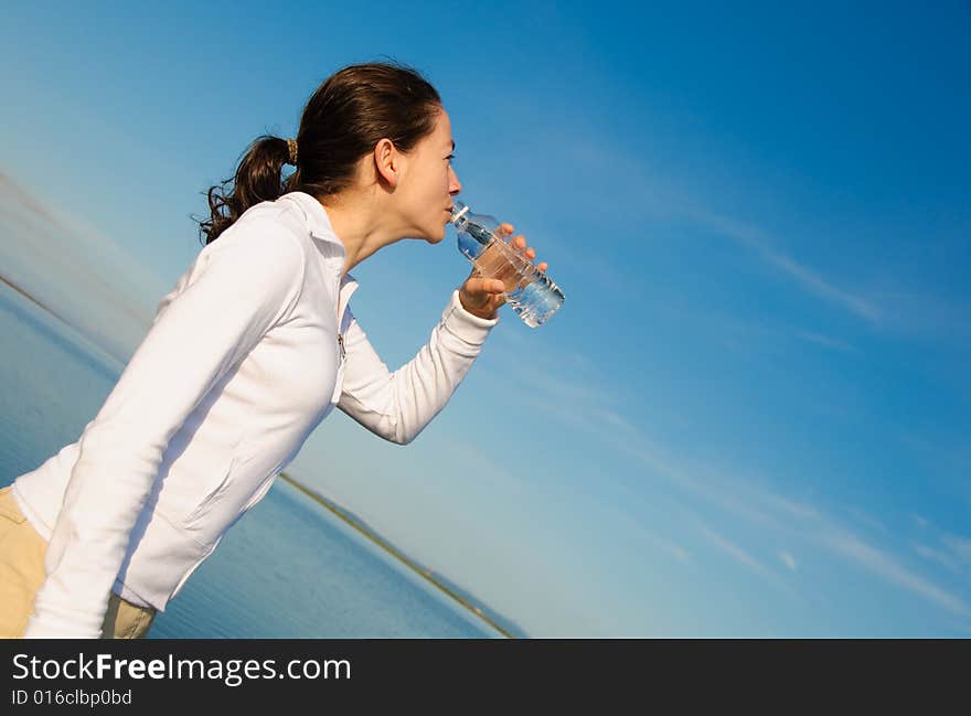 Drinking Woman with a blue sky outside