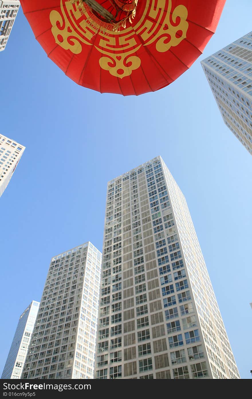 Red lantern and  skyscraper with blue sky in Beijing CBD(Central Business District),China. tradition   VS modern. Red lantern and  skyscraper with blue sky in Beijing CBD(Central Business District),China. tradition   VS modern