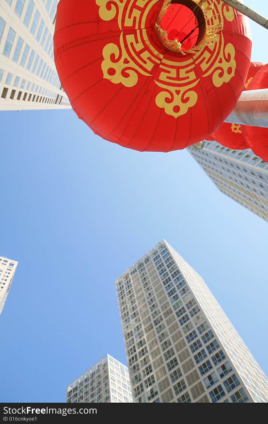 Red lantern and  skyscraper with blue sky in Beijing CBD(Central Business District),China. tradition   VS modern. Red lantern and  skyscraper with blue sky in Beijing CBD(Central Business District),China. tradition   VS modern