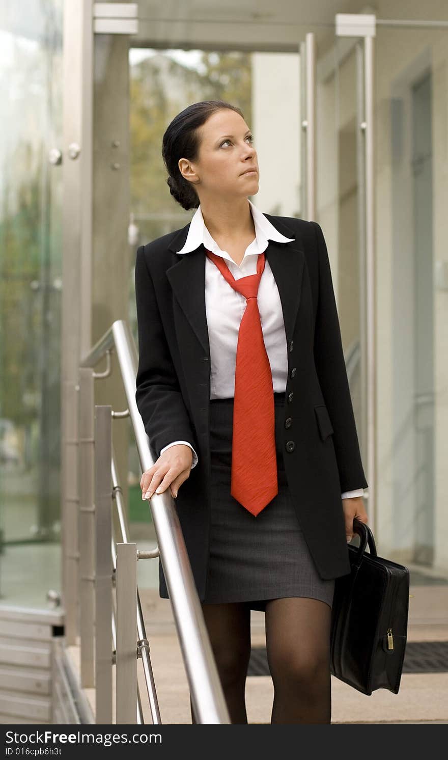 Outdoor portrait of businesswoman with portfolio