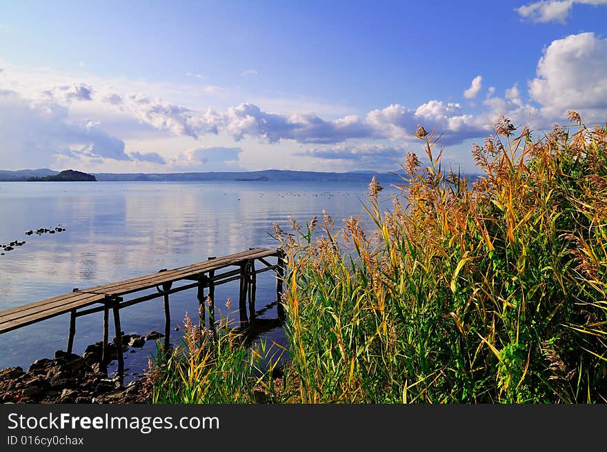 Lake view with bright sky, Typical plants and an harbor