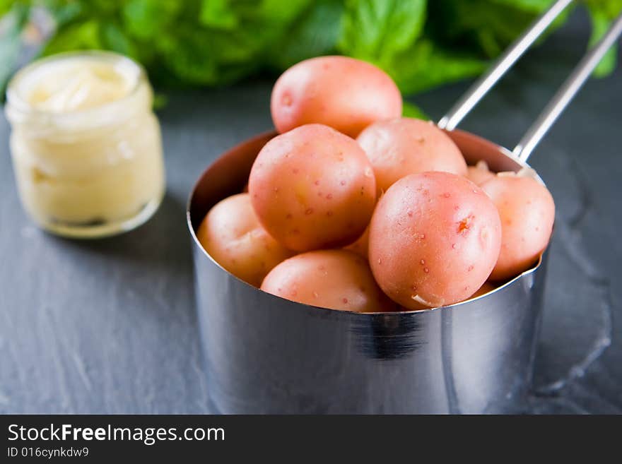 New potatoes in a small pan with butter