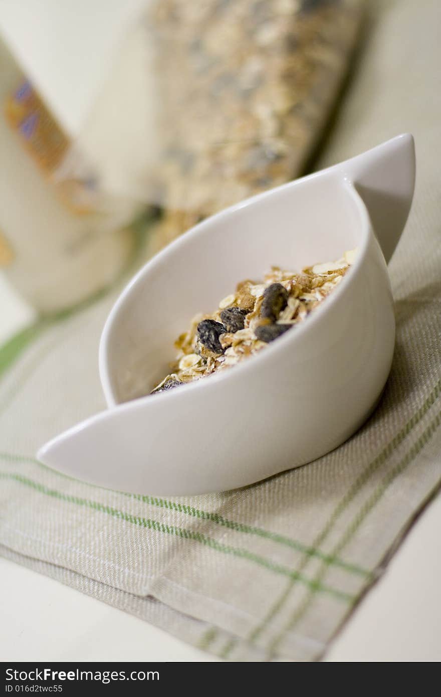 Bowl full of musli and bottle of milk