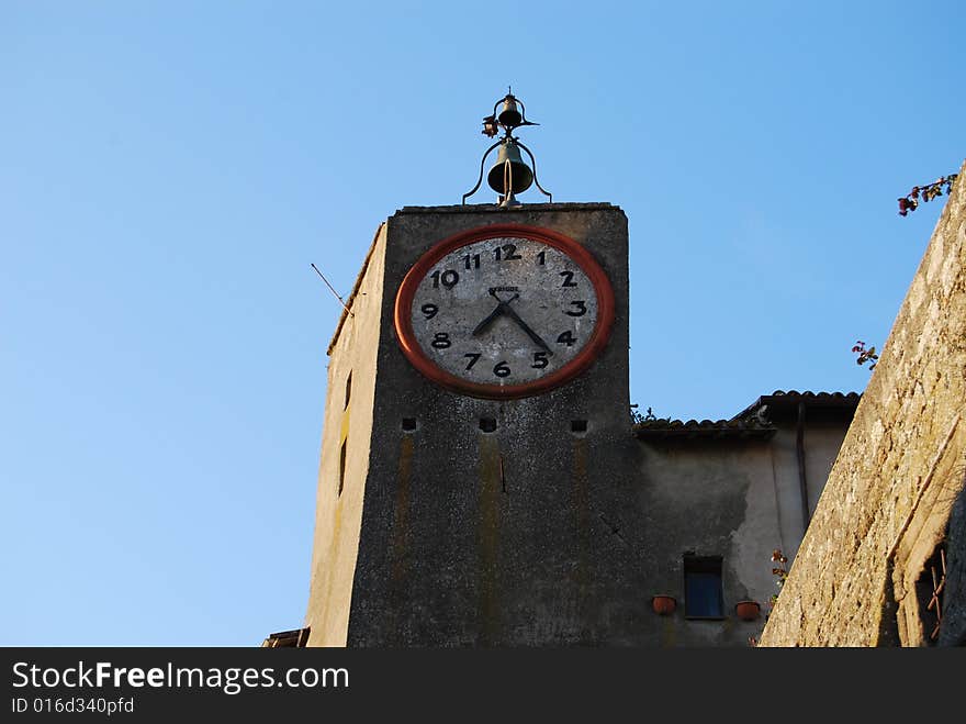 Ancient clock with bell in Orvieto, Italy