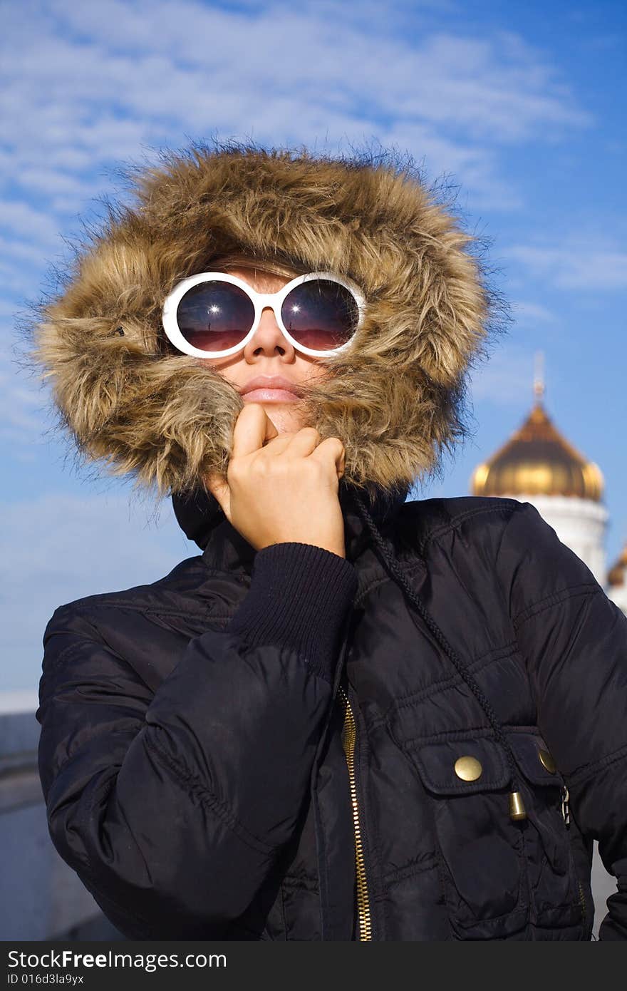 Beautiful girl in big white sun glasses and black jacket. Beautiful girl in big white sun glasses and black jacket