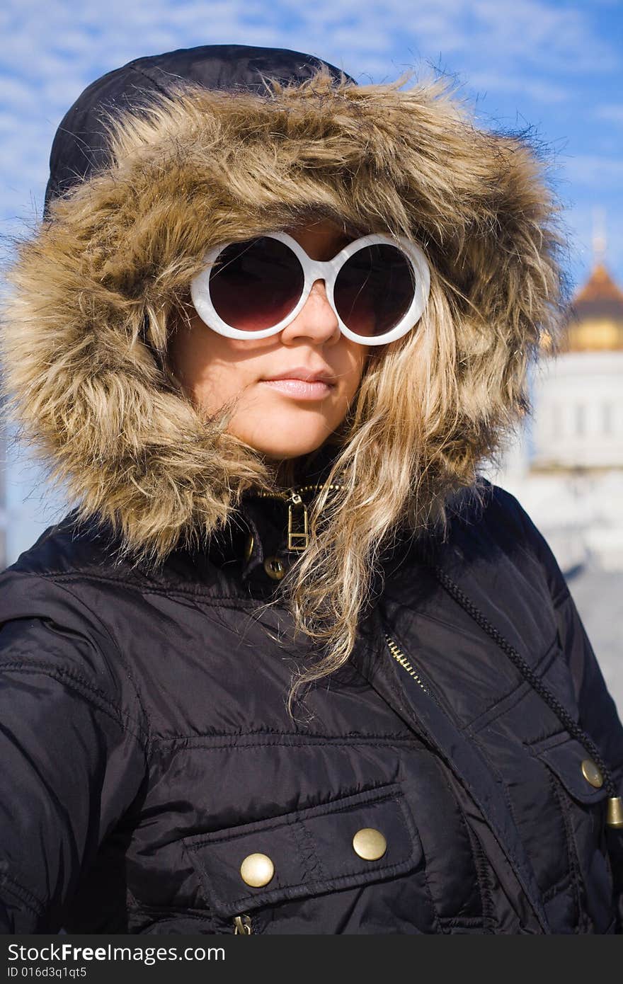 Beautiful girl in big white sun glasses and black jacket. Beautiful girl in big white sun glasses and black jacket