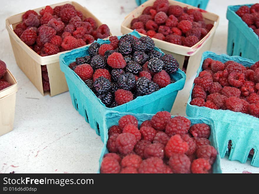 Freshly picked raspberries in carton boxes. Freshly picked raspberries in carton boxes.