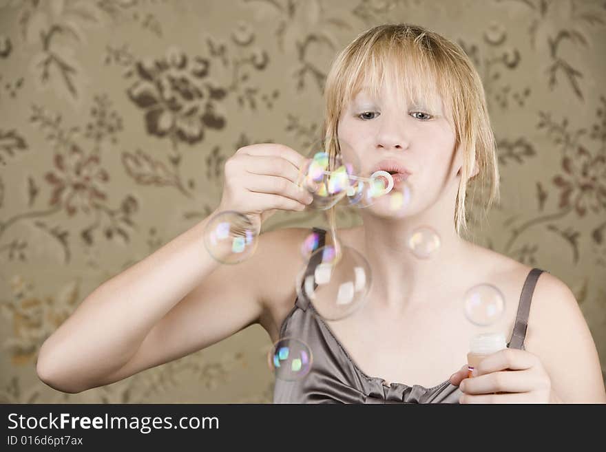 Pretty young girl blowing bubbles