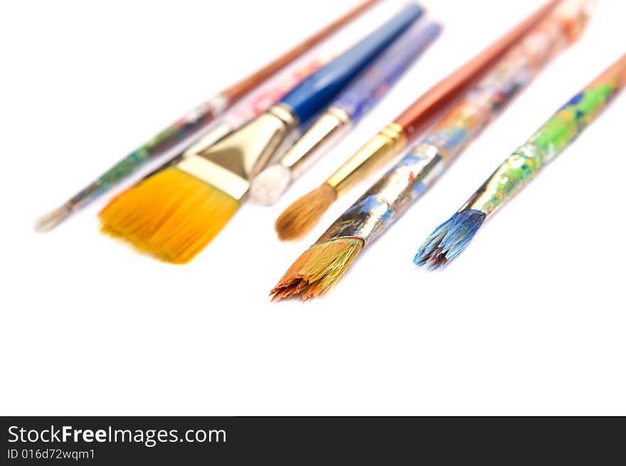 Colorful paint brushes on a white background. Colorful paint brushes on a white background