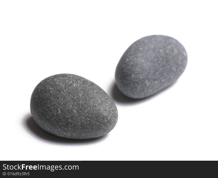 Two smooth stones on white background. Two smooth stones on white background