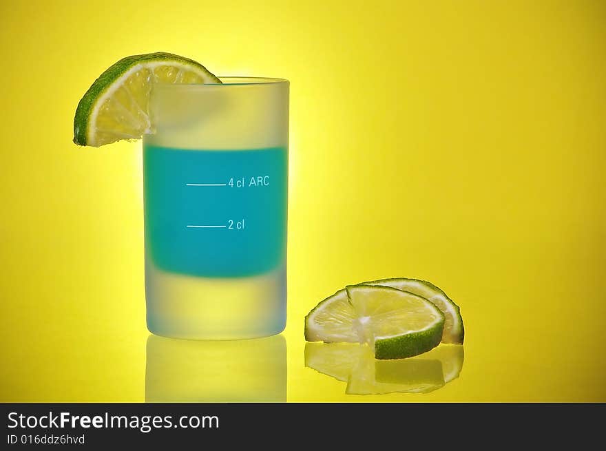 Shot Glass With Blue Tequila Shooter and Lime