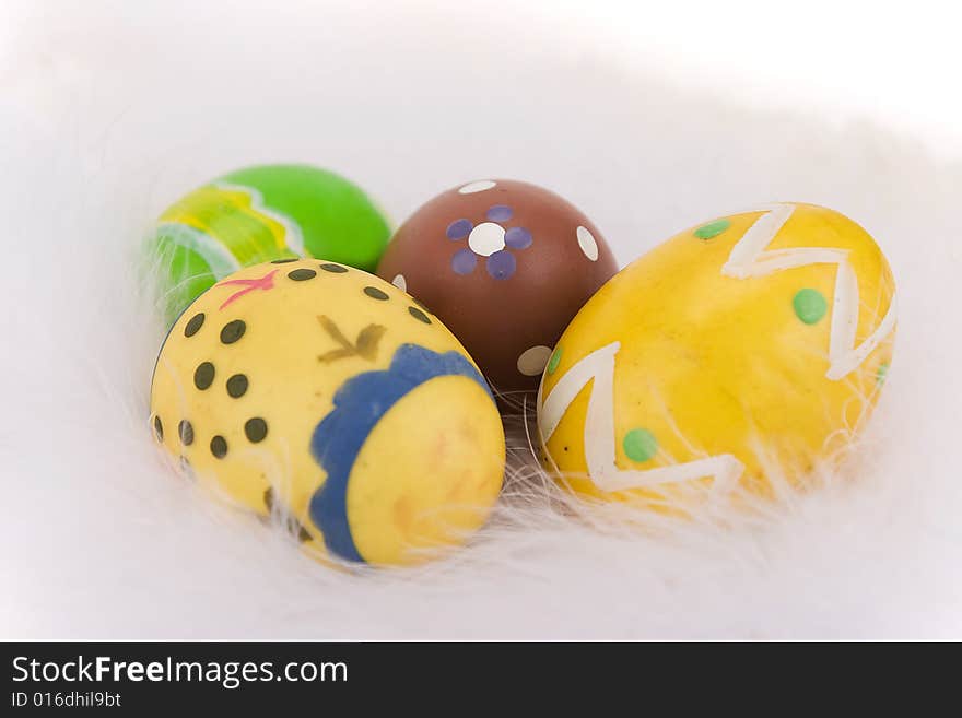 Colorful Easter eggs isolated on a white feathers