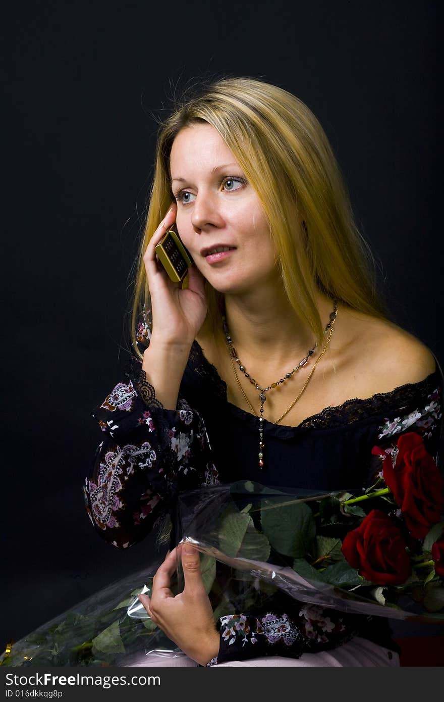 Long hair blonde woman with bunch of flowers and mobile phone. Long hair blonde woman with bunch of flowers and mobile phone