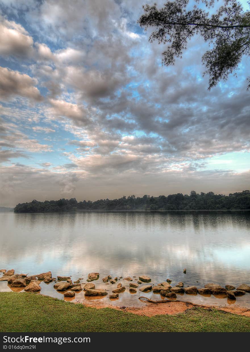 Cloudfilled skies in the morning over a lake. Cloudfilled skies in the morning over a lake