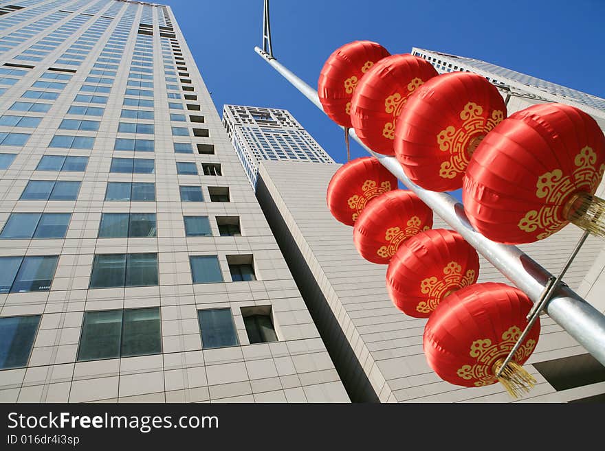 Red lantern and  skyscraper with blue sky in Beijing CBD(Central Business District),China. tradition   VS modern. Red lantern and  skyscraper with blue sky in Beijing CBD(Central Business District),China. tradition   VS modern