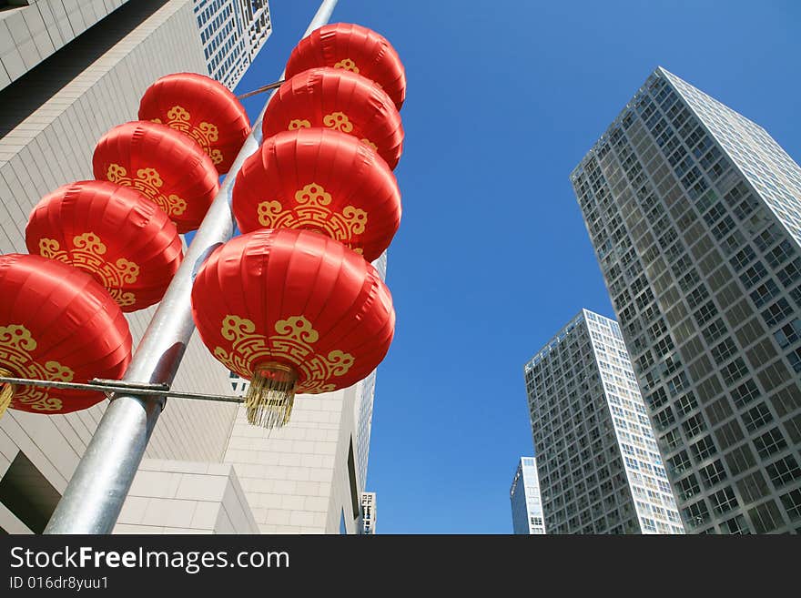 Red lantern and  skyscraper with blue sky in Beijing CBD(Central Business District),China. tradition   VS modern. Red lantern and  skyscraper with blue sky in Beijing CBD(Central Business District),China. tradition   VS modern