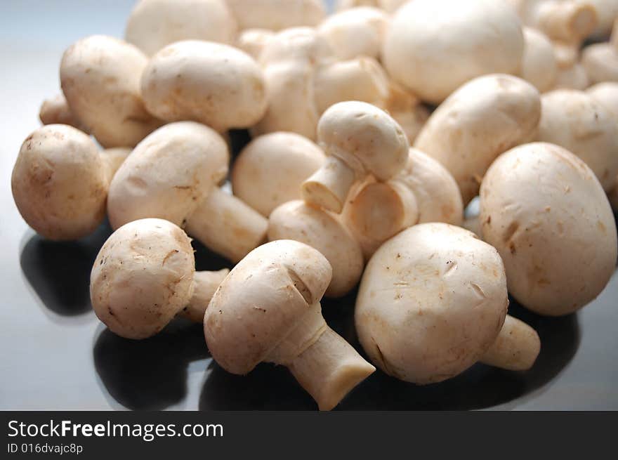 White mushrooms - champignons - on black background