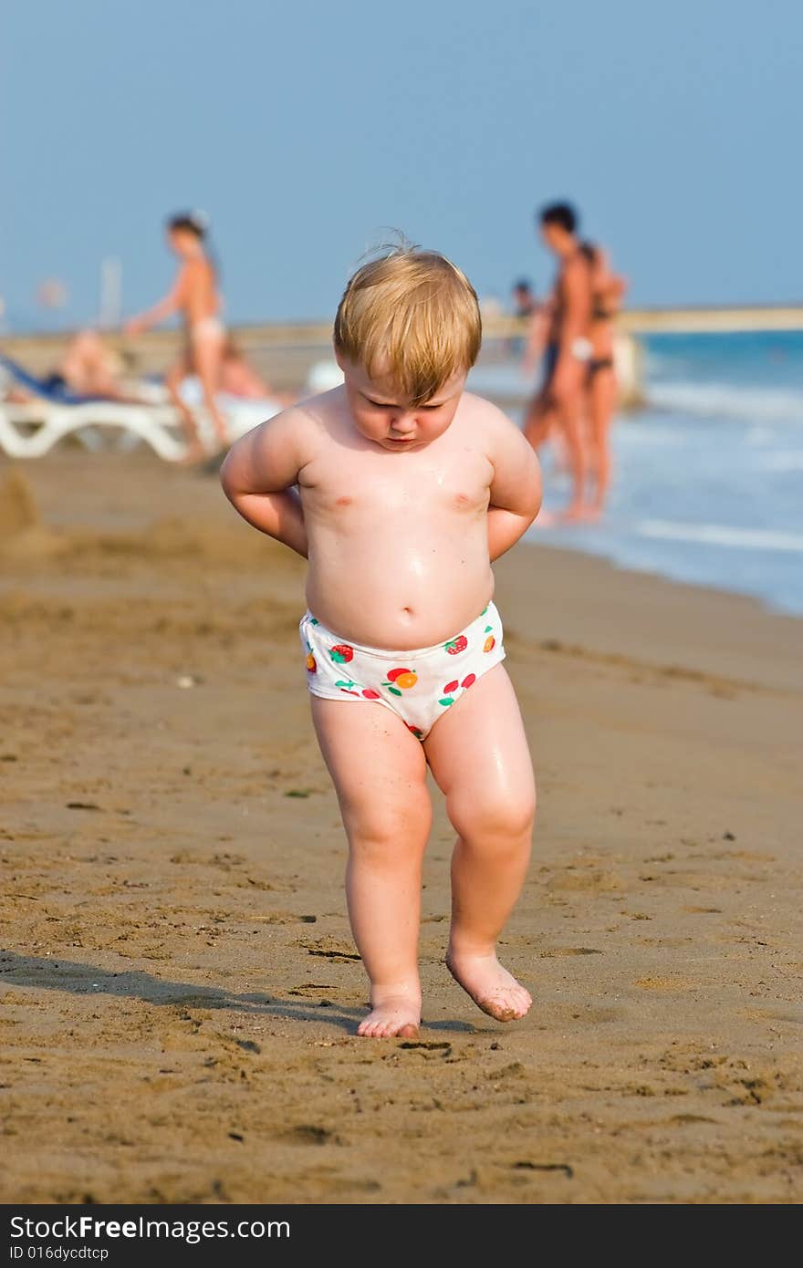 Thoughtful child goes on a sea beach