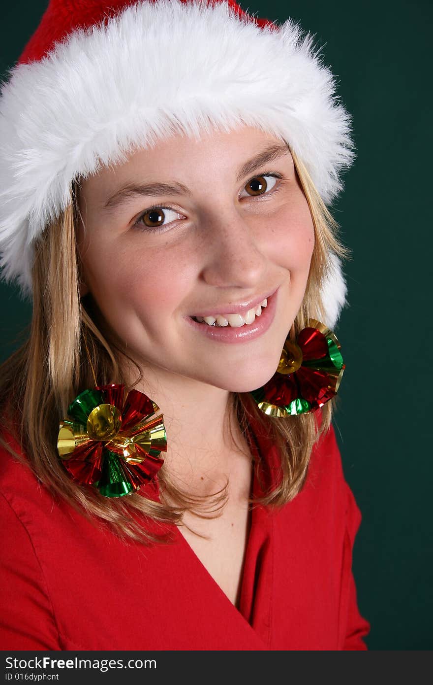 Beautiful teenager wearing a red shirt and christmas hat. Beautiful teenager wearing a red shirt and christmas hat