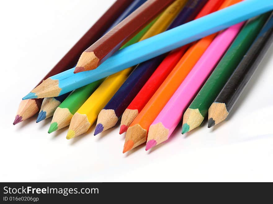 Color pencils in arrange in color wheel colors on white background