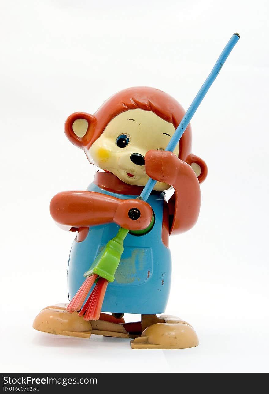 Old plastic monkey toy with broom