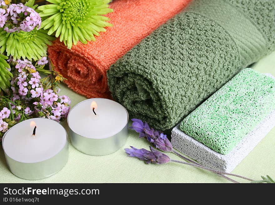 Spa Accessories setting with face cloths, candles and flowers. Spa Accessories setting with face cloths, candles and flowers