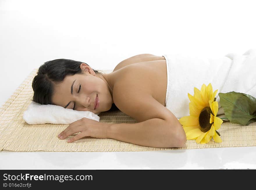 A female sleeping on mat with sunflower