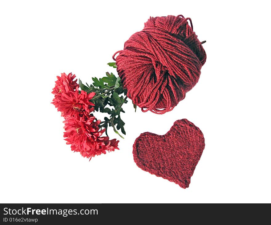 Cherry chrysanthemums, skein and knitted heart on white background. Cherry chrysanthemums, skein and knitted heart on white background