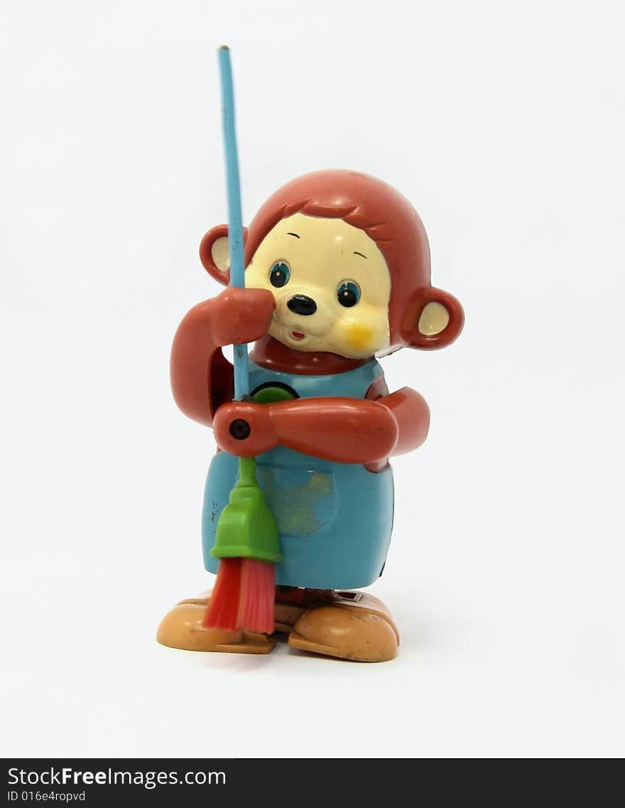 Old plastic monkey toy with broom