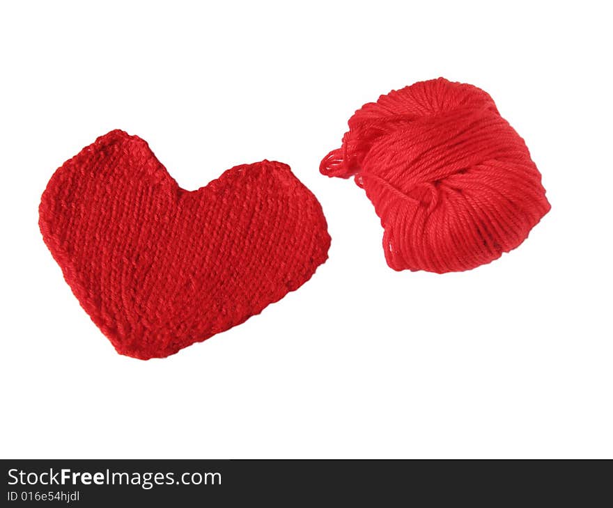 Red skein and knitted heart on white background. Red skein and knitted heart on white background