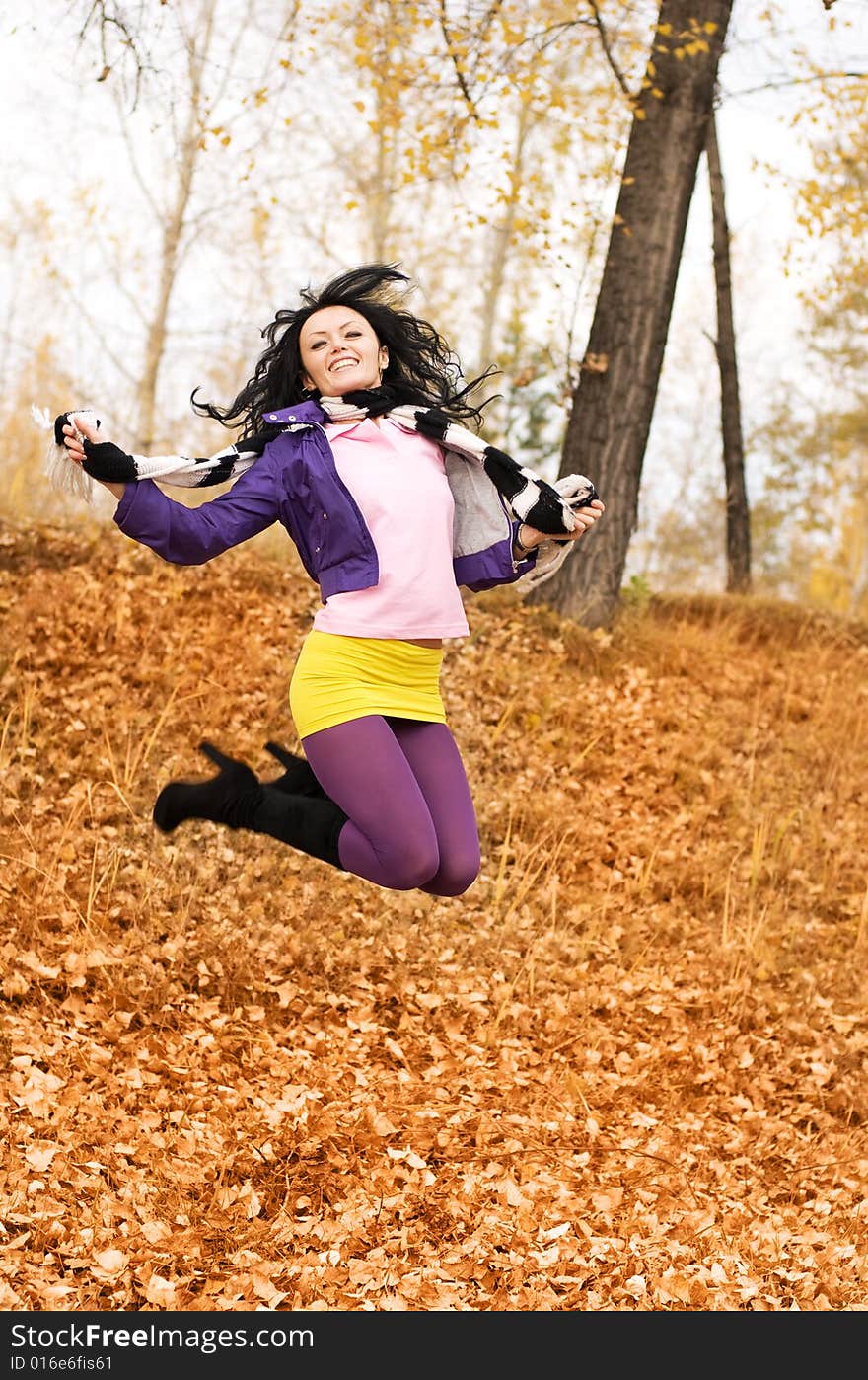 Happy smiling jumping girl in the park. Happy smiling jumping girl in the park