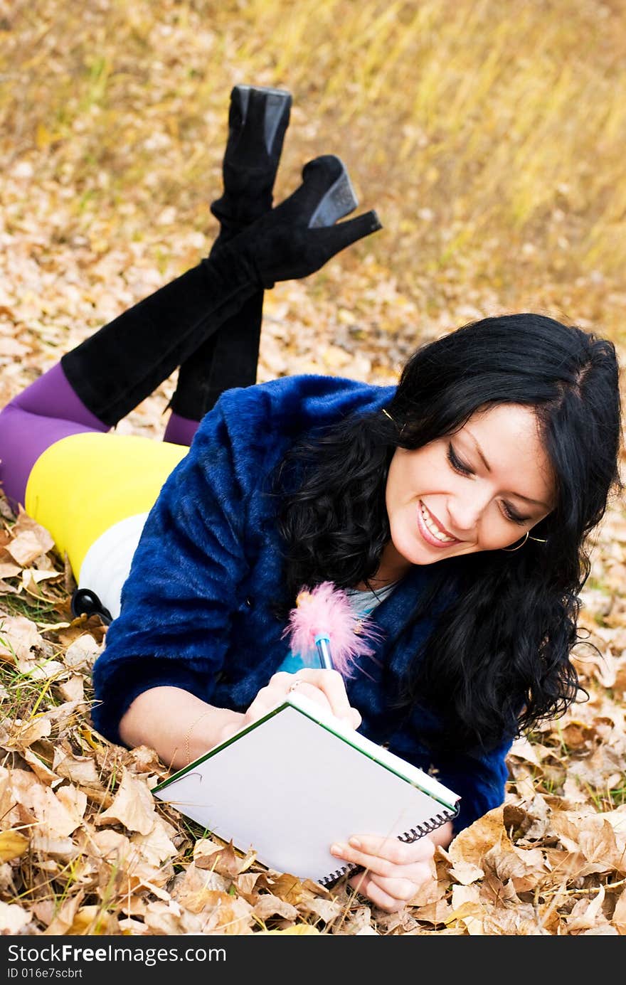 Pretty student doing homework in the park. Pretty student doing homework in the park