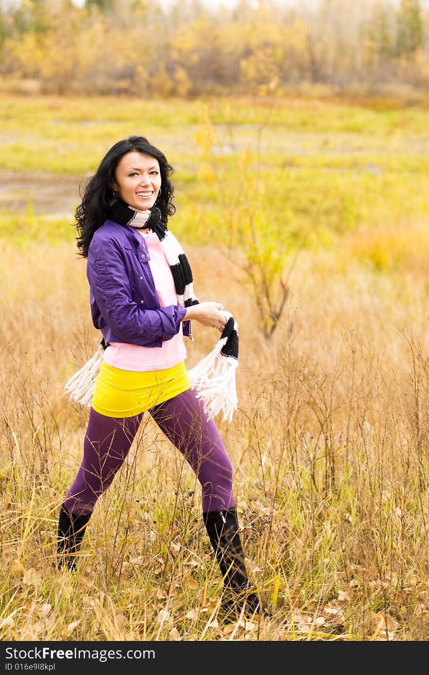 Beautiful brunette girl walking alone in the park. Beautiful brunette girl walking alone in the park