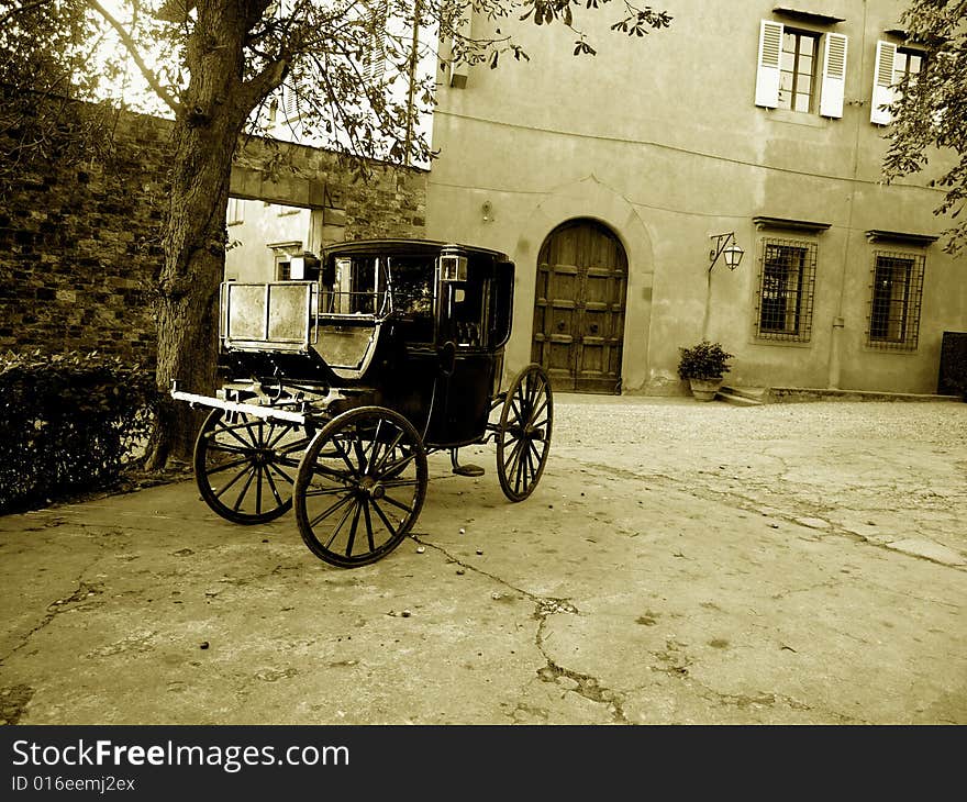 A suggestive monochrome of an old carriage in a historic house in Florence countryside