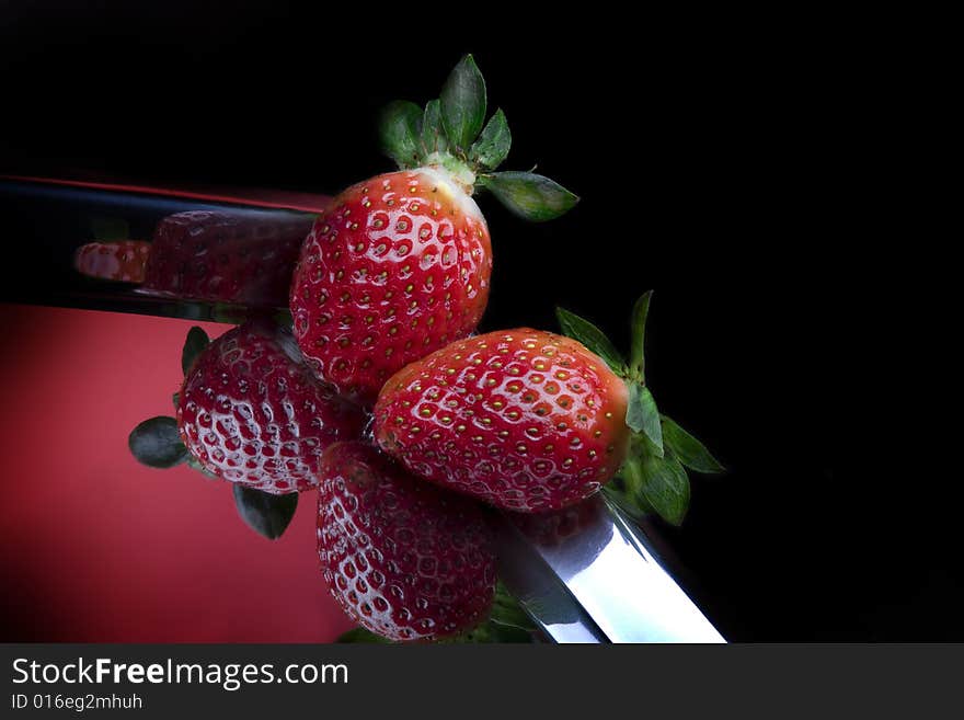 Close up view of  nice fresh strawberry on black back. Close up view of  nice fresh strawberry on black back