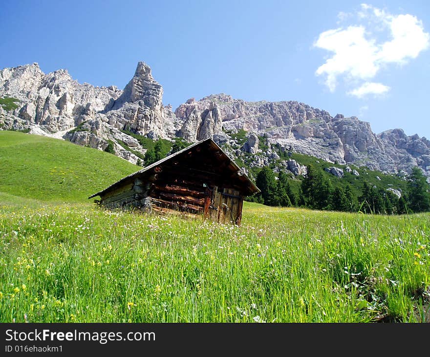 A suggestive shot of a relaxing landscape of a mountain and a cottage. A suggestive shot of a relaxing landscape of a mountain and a cottage