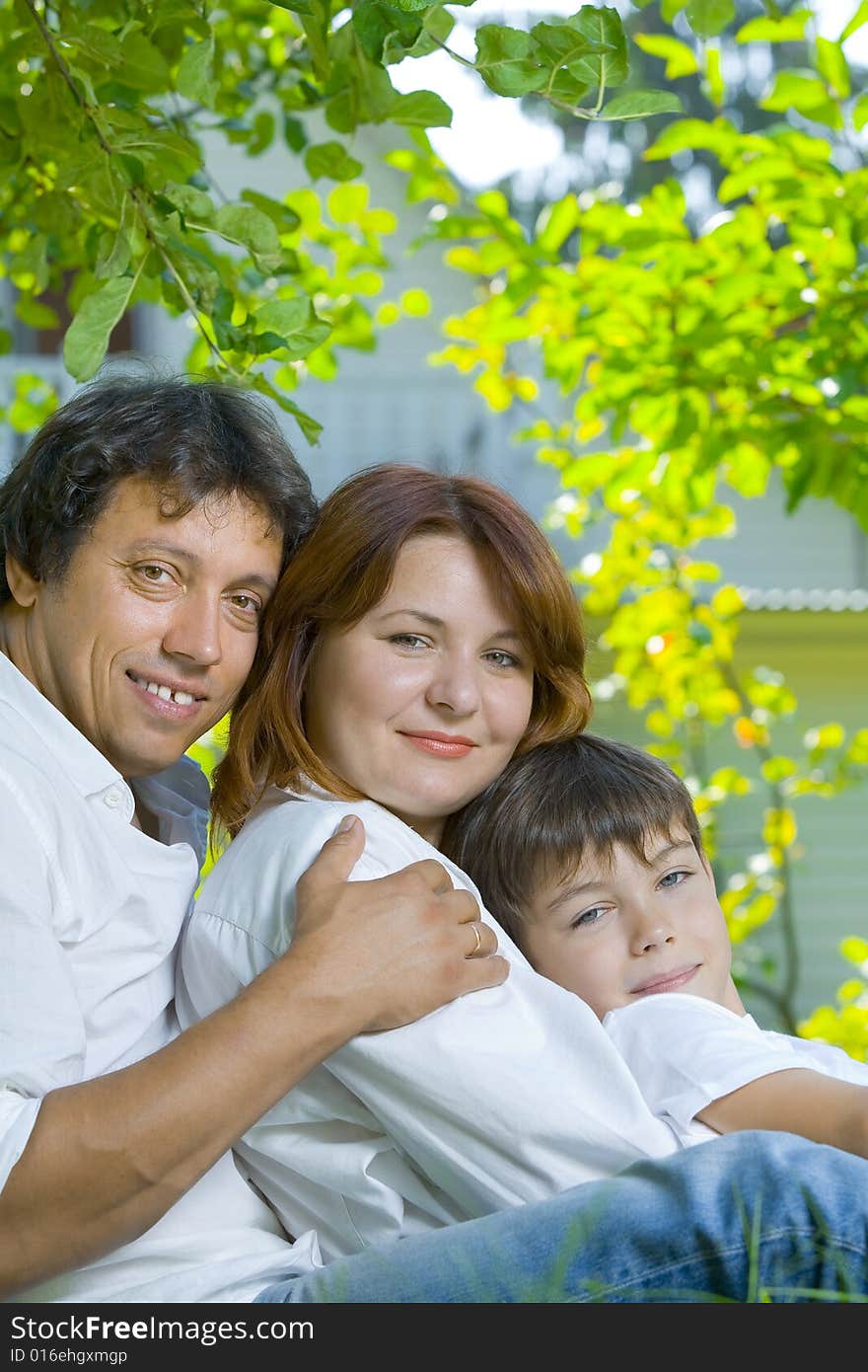 Portrait of young happy family in summer environment. Portrait of young happy family in summer environment