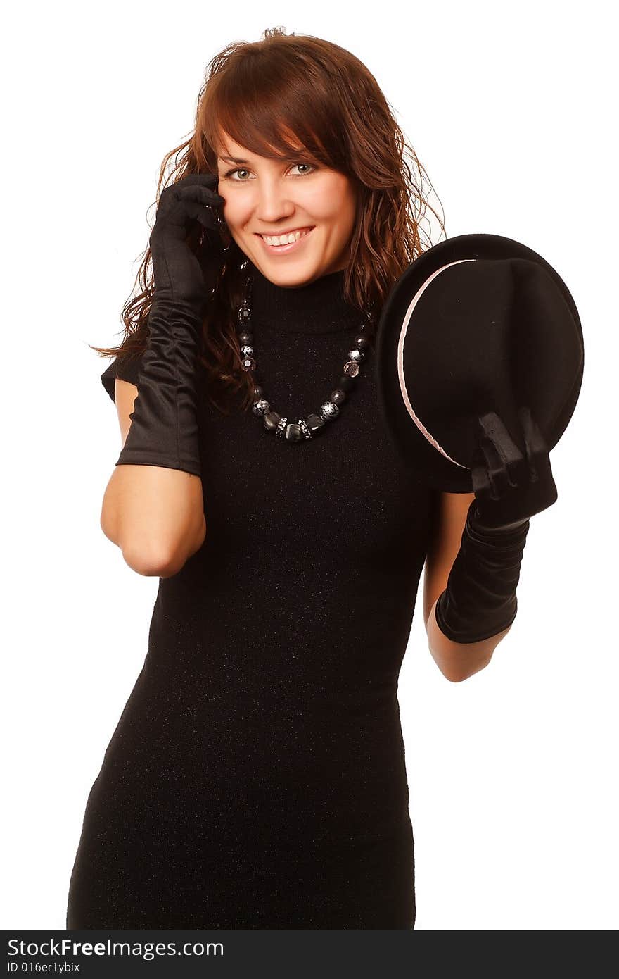 The girl in black clothes on a white background with a hat hat