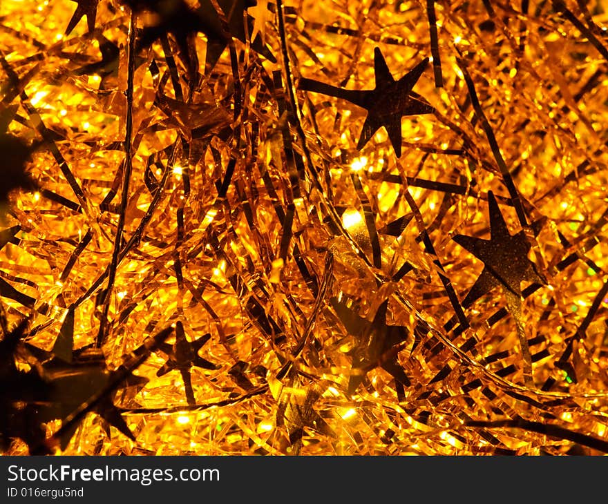 Illuminated golden Christmas tinsel background. Illuminated golden Christmas tinsel background