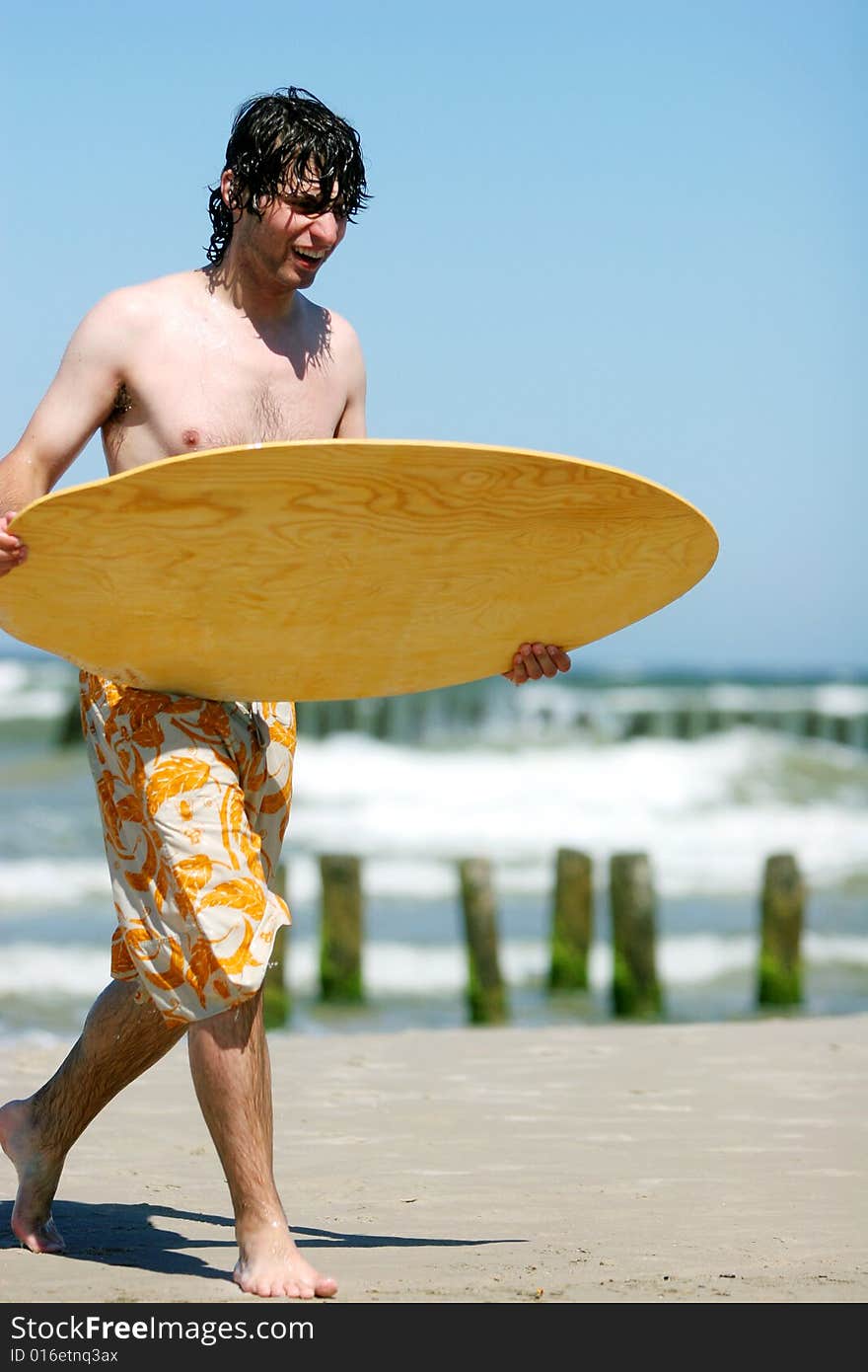 Skimboarder on beach