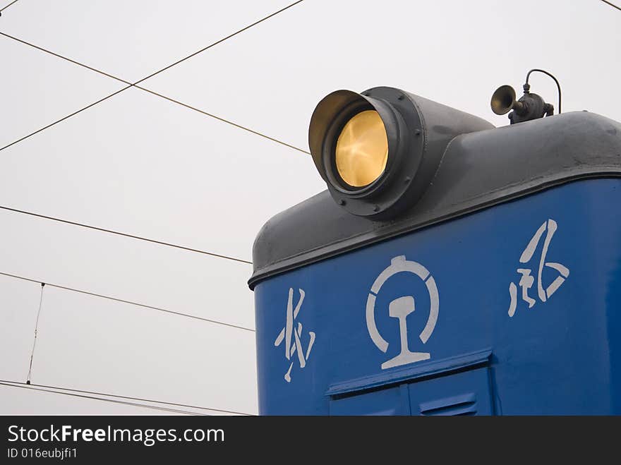 Close-up of a locomotive with backgroud of railway systems