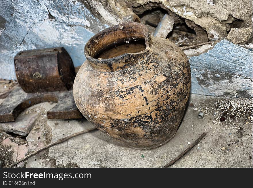 Handmade old jug, vintage against a ruinny background. Handmade old jug, vintage against a ruinny background