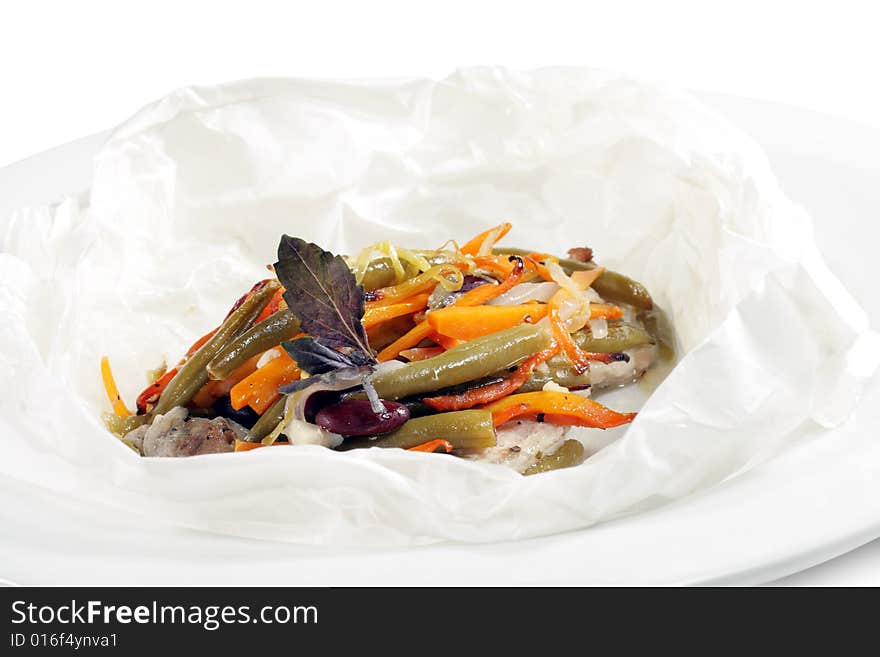 Pork and Vegetables Wrapped in Paper Served with Basil Leaves. Isolated on White Background. Pork and Vegetables Wrapped in Paper Served with Basil Leaves. Isolated on White Background